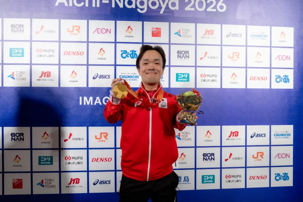 メダルと花束を手にミックスゾーンに立つ阿部隼万選手