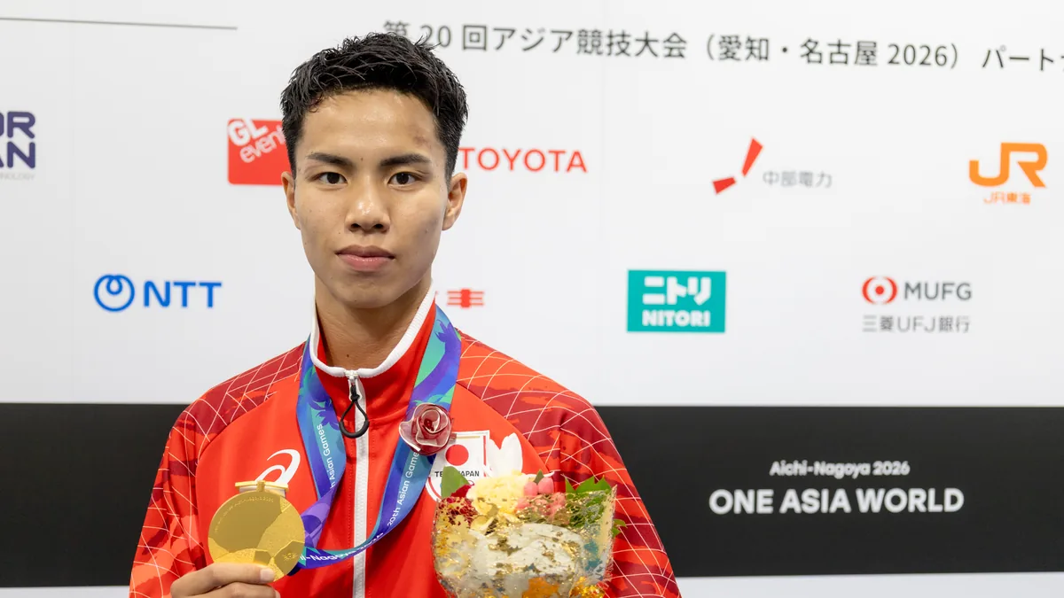金メダルと花束を手にするボクシングの山口瑠選手