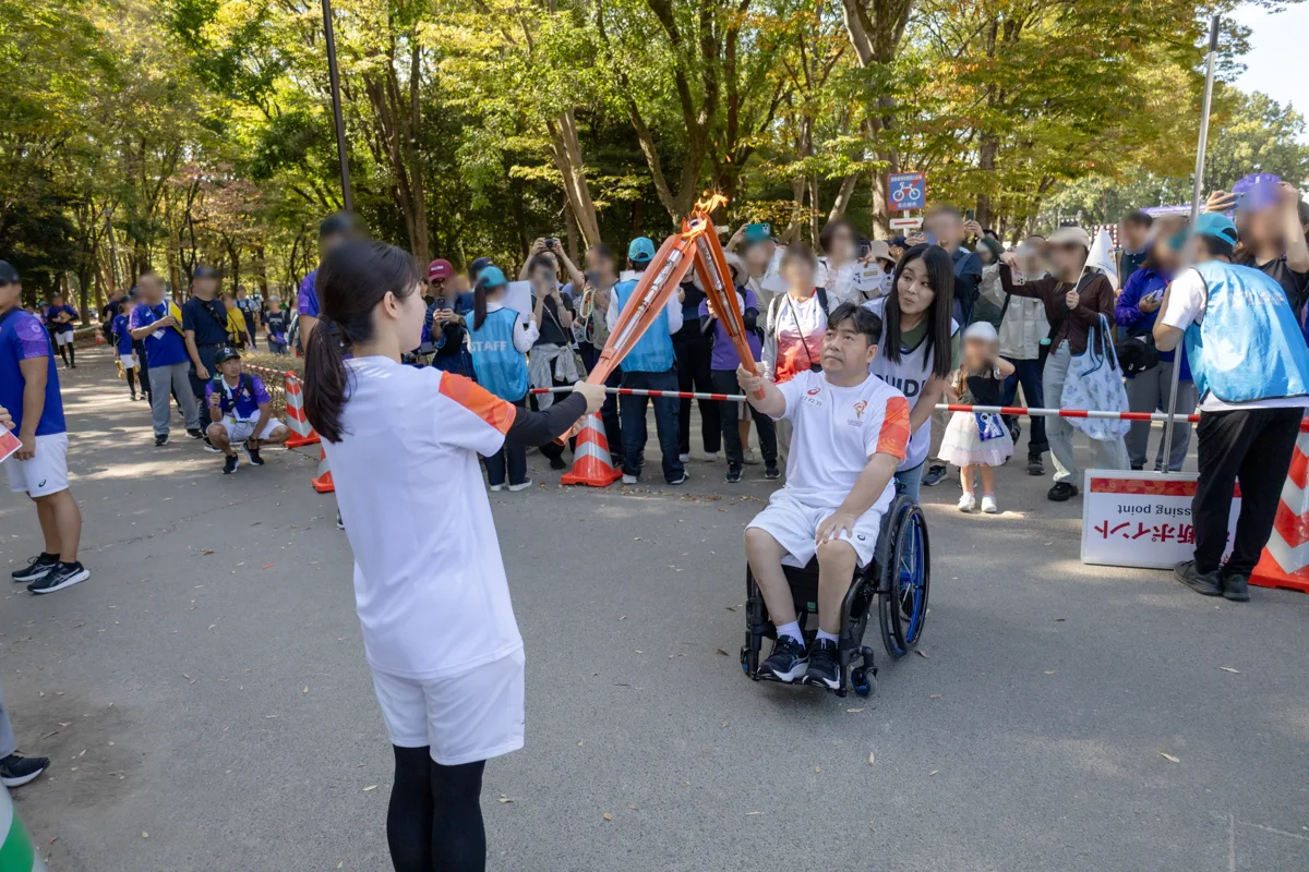 聖火を受け取った直後の大堂秀樹さんと伴走のガイド