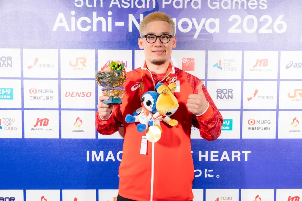 金メダルを手に親指を立てる宮食行次選手