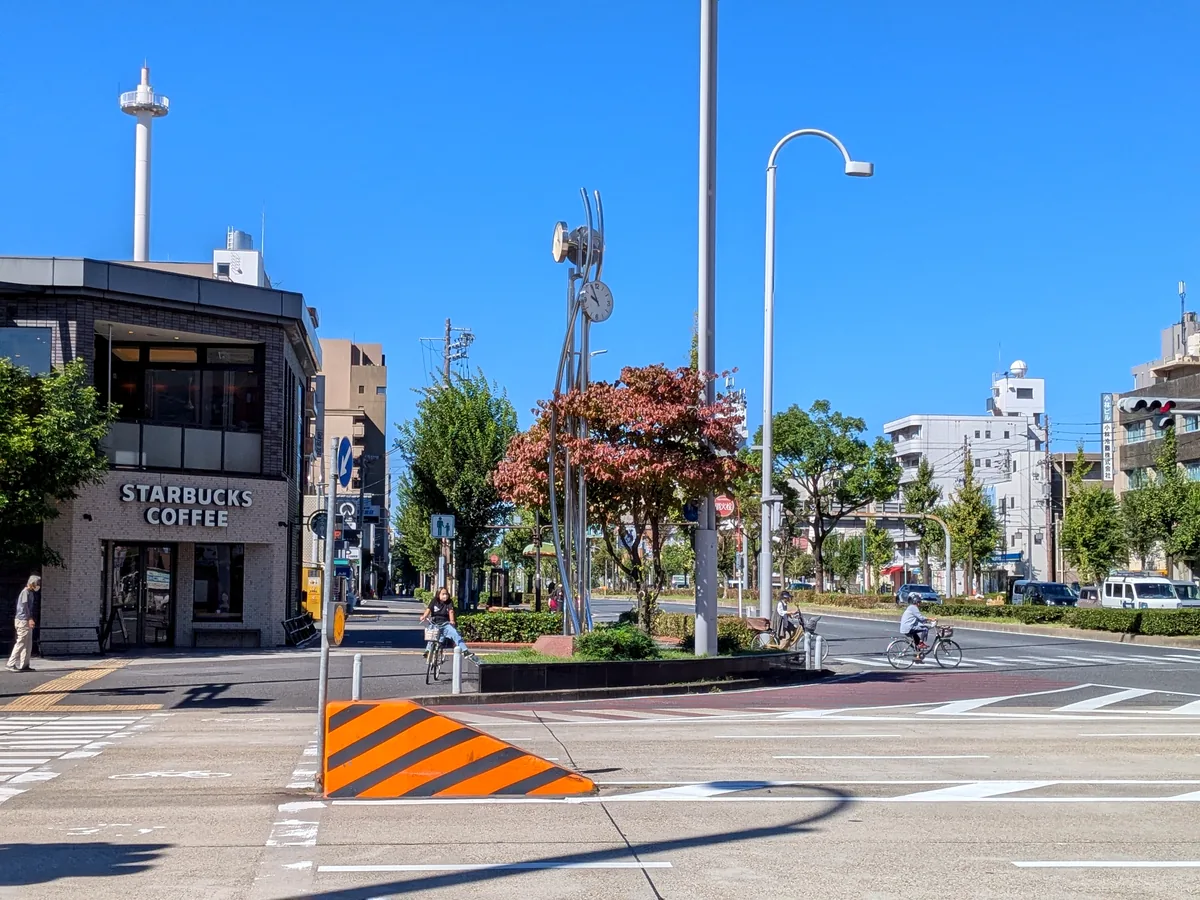 御器所通交差点の時計モニュメント越しに見るスターバックス御器所駅前店